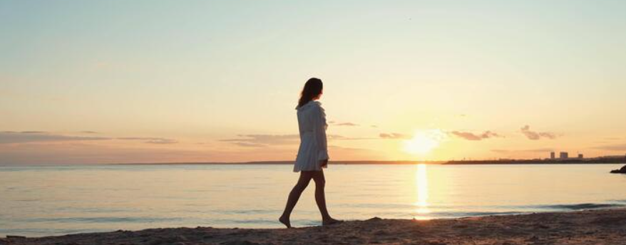 woman-yoga-heart-hand-shadow-sunset-beach-ocean-with-peace-zen-hands-sign